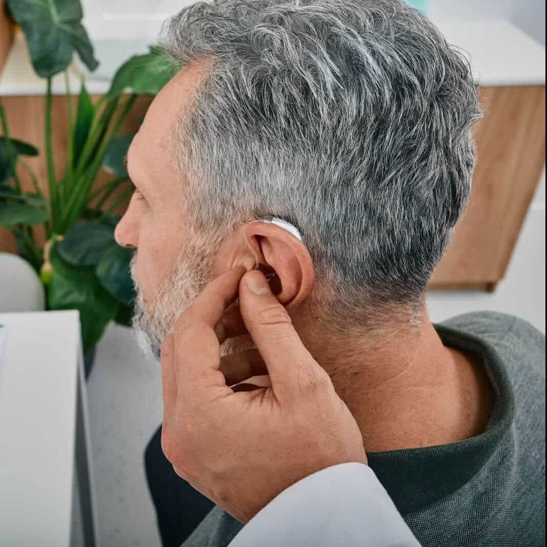 Elderly man with hearing aid