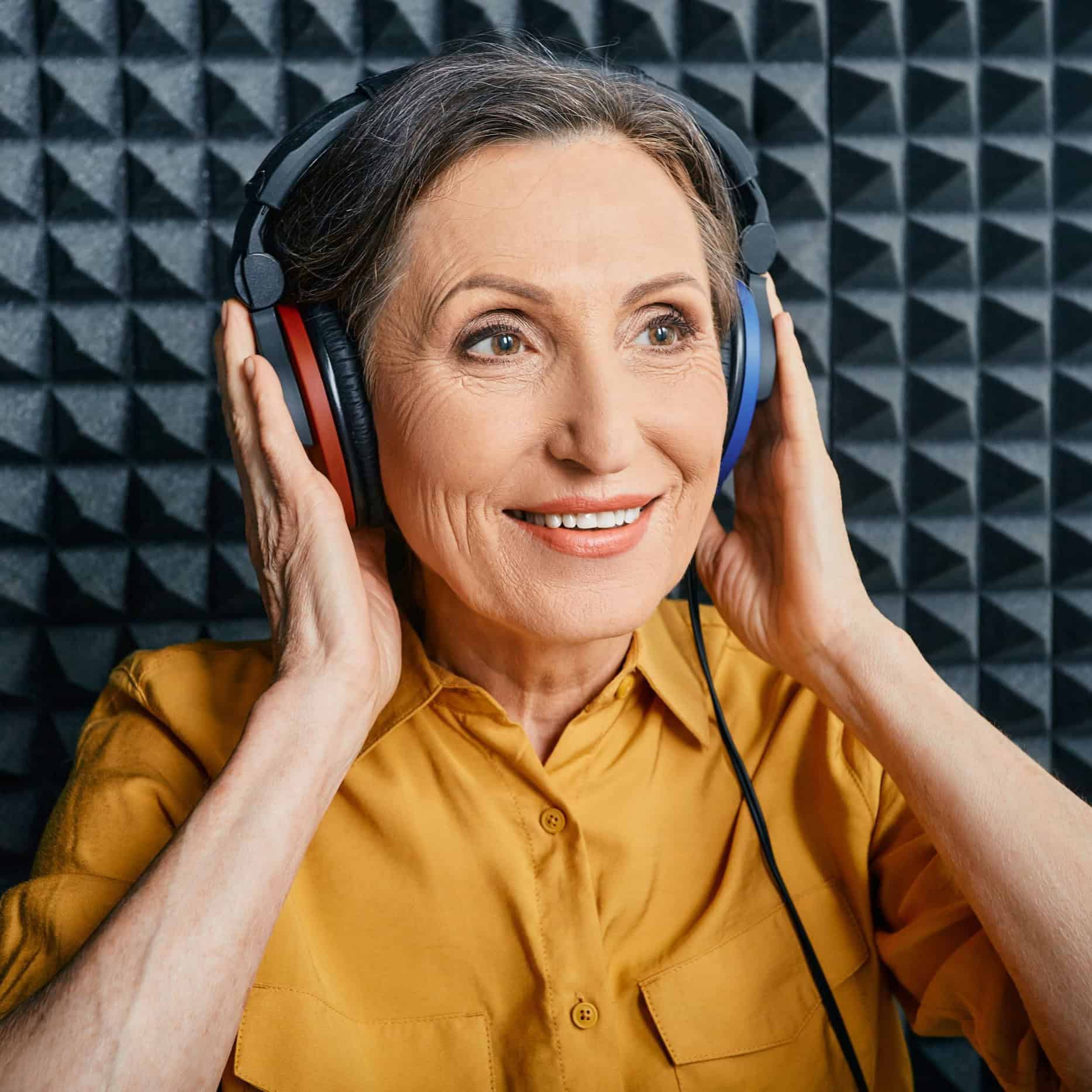 Woman in hearing booth getting hearing exam