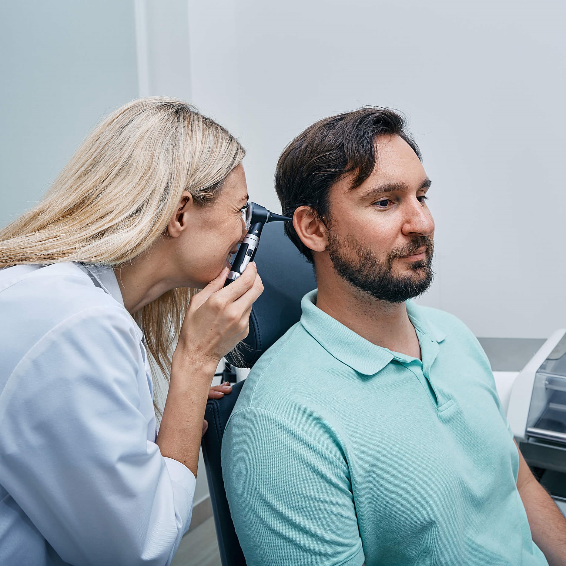 Male patient receiving hearing exam