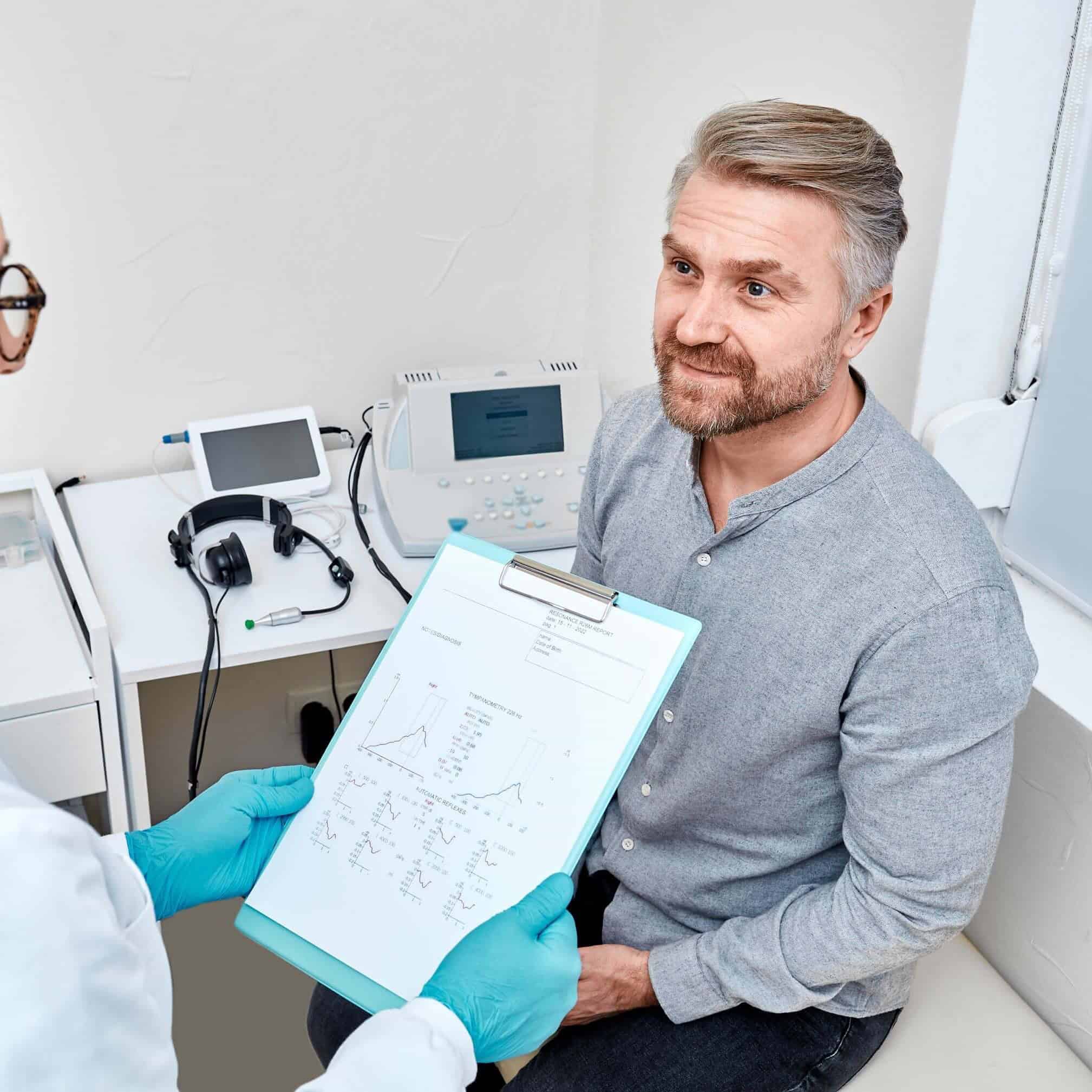 Man receiving positive hearing exam result