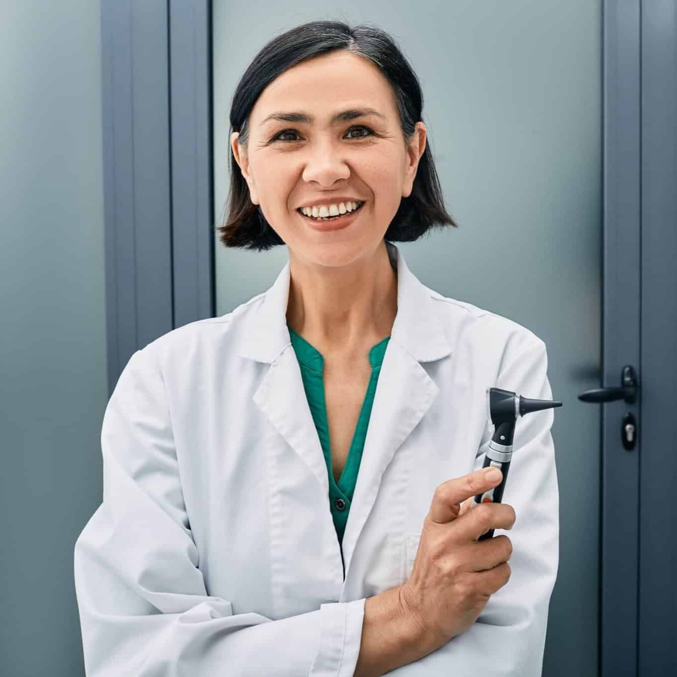 Female audiologist posing with otoscope